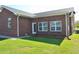 Brick home's back exterior featuring a well-kept lawn and several windows for natural light at 960 South Farr Ave., Andrews, SC 29510