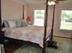 This bedroom features a four-poster bed with large windows providing ample natural light at 960 South Farr Ave., Andrews, SC 29510