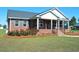 Brick home featuring a manicured lawn, black shutters, and attractive landscaping at 960 South Farr Ave., Andrews, SC 29510