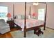 Comfortable main bedroom with a four-poster bed, bedside tables, and chair at 960 South Farr Ave., Andrews, SC 29510