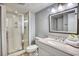 Well-lit bathroom featuring a glass-door shower and a vanity with a granite countertop at 101 Ocean Creek Dr. # Jj-1, Myrtle Beach, SC 29572