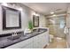 Bathroom featuring double sinks, granite counters, and glass enclosed shower at 101 Ocean Creek Dr. # Jj-1, Myrtle Beach, SC 29572