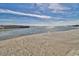 Expansive beach view showcasing calm waters and sandy shoreline under a blue sky at 101 Ocean Creek Dr. # Jj-1, Myrtle Beach, SC 29572