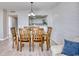 Bright dining room features wood table, chairs, and chandelier lighting, conveniently located near the modern kitchen at 101 Ocean Creek Dr. # Jj-1, Myrtle Beach, SC 29572