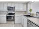 Modern white kitchen with stainless steel appliances including range, microwave, and dishwasher at 101 Ocean Creek Dr. # Jj-1, Myrtle Beach, SC 29572