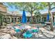 Charming outdoor patio seating area with blue umbrellas surrounded by lush greenery at 101 Ocean Creek Dr. # Jj-1, Myrtle Beach, SC 29572