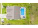 Bird's eye view of a home and enclosed pool that is surrounded by a green lawn and manicured flower beds at 1109 Donald St., Conway, SC 29527