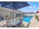 Outdoor living area with patio furniture beneath a large shade umbrella by the pool at 1109 Donald St., Conway, SC 29527