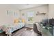 Bright bedroom features coastal decor, a gray desk, wood floors, and a sunlit window at 1109 Donald St., Conway, SC 29527