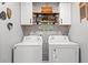 Well-organized laundry room with overhead cabinets, a shelf, and modern appliances at 1109 Donald St., Conway, SC 29527