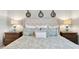 Stylish primary bedroom features a luxurious king bed with plush pillows and matching nightstands at 1148 Blueback Herring Way # 146, Conway, SC 29526