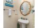 Cozy half bathroom with a pedestal sink, an ornate mirror and nautical-themed decor at 124 B Vista Dr., Murrells Inlet, SC 29576