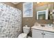 Neutral-toned bathroom with a shower featuring a marine-themed curtain, and a vanity with a white marble top at 124 B Vista Dr., Murrells Inlet, SC 29576