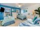 Bright bedroom featuring three twin beds with blue accents, a white dresser, and beach-themed decor at 124 B Vista Dr., Murrells Inlet, SC 29576