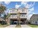 Charming raised beach house boasts double balconies, dual driveways, and ample parking space at 124 B Vista Dr., Murrells Inlet, SC 29576