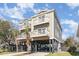 Inviting raised beach home featuring double balconies and a spacious underneath parking area at 124 B Vista Dr., Murrells Inlet, SC 29576