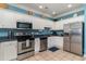 Well-lit kitchen featuring stainless steel appliances, ample white cabinetry, and a light blue accent wall at 124 B Vista Dr., Murrells Inlet, SC 29576