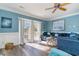 Bright living room featuring blue walls, stylish furnishings, and sliding doors to the balcony at 124 B Vista Dr., Murrells Inlet, SC 29576