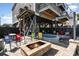 Inviting backyard patio featuring a brick fire pit and lounge seating near the private pool under the elevated beach home at 124 B Vista Dr., Murrells Inlet, SC 29576