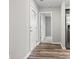 Hallway features wood floors, white trim, and leads into a room with gray carpet at 125 South Shore Blvd. # 201, Longs, SC 29568