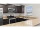 Kitchen showcasing granite countertops, stainless steel appliances, and dark cabinetry at 125 South Shore Blvd. # 201, Longs, SC 29568