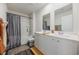 Bathroom featuring double vanity sinks, a shower with tub, and neutral decor at 128 Caveson Way, Conway, SC 29526