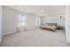 Spacious bedroom with neutral carpet, light walls, and lots of natural light from two windows at 128 Caveson Way, Conway, SC 29526