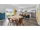 Open floor plan with a kitchen island featuring barstool seating and adjacent dining area at 128 Caveson Way, Conway, SC 29526