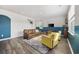 Cozy living area with a brown leather sofa, yellow armchairs, and hardwood floors at 128 Caveson Way, Conway, SC 29526