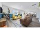 Open-concept living space with hardwood floors connecting the living, dining, and kitchen areas at 128 Caveson Way, Conway, SC 29526