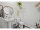 Bright powder room with pedestal sink, neutral walls, and minimalist decor at 128 Caveson Way, Conway, SC 29526