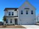 Charming two-story home featuring white siding, a covered porch, and an attached two-car garage at 1292 Safe Haven Dr., Myrtle Beach, SC 29579