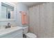 Bathroom featuring a white toilet, sink, and seashell-patterned shower curtain at 1305 S Ocean Blvd. # 204, North Myrtle Beach, SC 29582