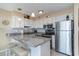 Efficient kitchen with stainless steel appliances and breakfast bar seating at 1305 S Ocean Blvd. # 204, North Myrtle Beach, SC 29582