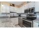 Well-equipped kitchen with white cabinets, stainless steel appliances, and granite countertops at 1305 S Ocean Blvd. # 204, North Myrtle Beach, SC 29582