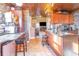 A kitchen with dark wood cabinets, granite countertops, tile floor and copper colored tile ceiling at 1356 Glenns Bay Rd. # 204D, Surfside Beach, SC 29575