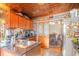 A kitchen with granite counters, dark wood cabinets, view to the dining area and copper colored ceiling at 1356 Glenns Bay Rd. # 204D, Surfside Beach, SC 29575