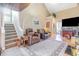 This cozy living room has seating, stairs to the upper floor, unique ceiling and hardwood floors at 1356 Glenns Bay Rd. # 204D, Surfside Beach, SC 29575