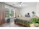 This bedroom features a large window, a ceiling fan, and a bed with a patterned comforter at 1409 Highway 15 # 4, Myrtle Beach, SC 29577