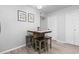 Dining table and stools adjacent to an exterior door with wall art and updated flooring at 1409 Highway 15 # 4, Myrtle Beach, SC 29577