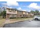 A row of brick townhomes, each with individual entrances and landscaping, creating a cohesive neighborhood feel at 1409 Highway 15 # 4, Myrtle Beach, SC 29577