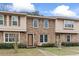 Traditional brick townhome featuring shuttered windows and manicured landscaping on a sunny day at 1409 Highway 15 # 4, Myrtle Beach, SC 29577