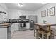 Bright kitchen with stainless steel appliances and white cabinets paired with bar height dining area at 1409 Highway 15 # 4, Myrtle Beach, SC 29577