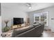 Light-filled living room showcases a gray sofa, media center, and ceiling fan at 1409 Highway 15 # 4, Myrtle Beach, SC 29577