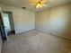 Spacious carpeted bedroom featuring a ceiling fan and ample natural light through a window at 1506 Havens Dr. # H, North Myrtle Beach, SC 29582