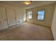 Bright bedroom with natural light, neutral carpet, and closet space at 1506 Havens Dr. # H, North Myrtle Beach, SC 29582