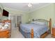 Bedroom with blue bedding, wooden dresser, ceiling fan and access to screened-in patio with swimming pool view at 1529 Lanterns Rest Dr. # 201, Myrtle Beach, SC 29579