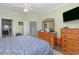 Bedroom with blue bedding, wooden dresser, and ceiling fan; en-suite bathroom and walk-in closet can be seen at 1529 Lanterns Rest Dr. # 201, Myrtle Beach, SC 29579