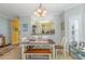 Dining room with a view into the kitchen featuring plantation shutters and modern lighting at 1529 Lanterns Rest Dr. # 201, Myrtle Beach, SC 29579