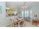 Dining room with a view into the kitchen featuring plantation shutters and modern lighting at 1529 Lanterns Rest Dr. # 201, Myrtle Beach, SC 29579